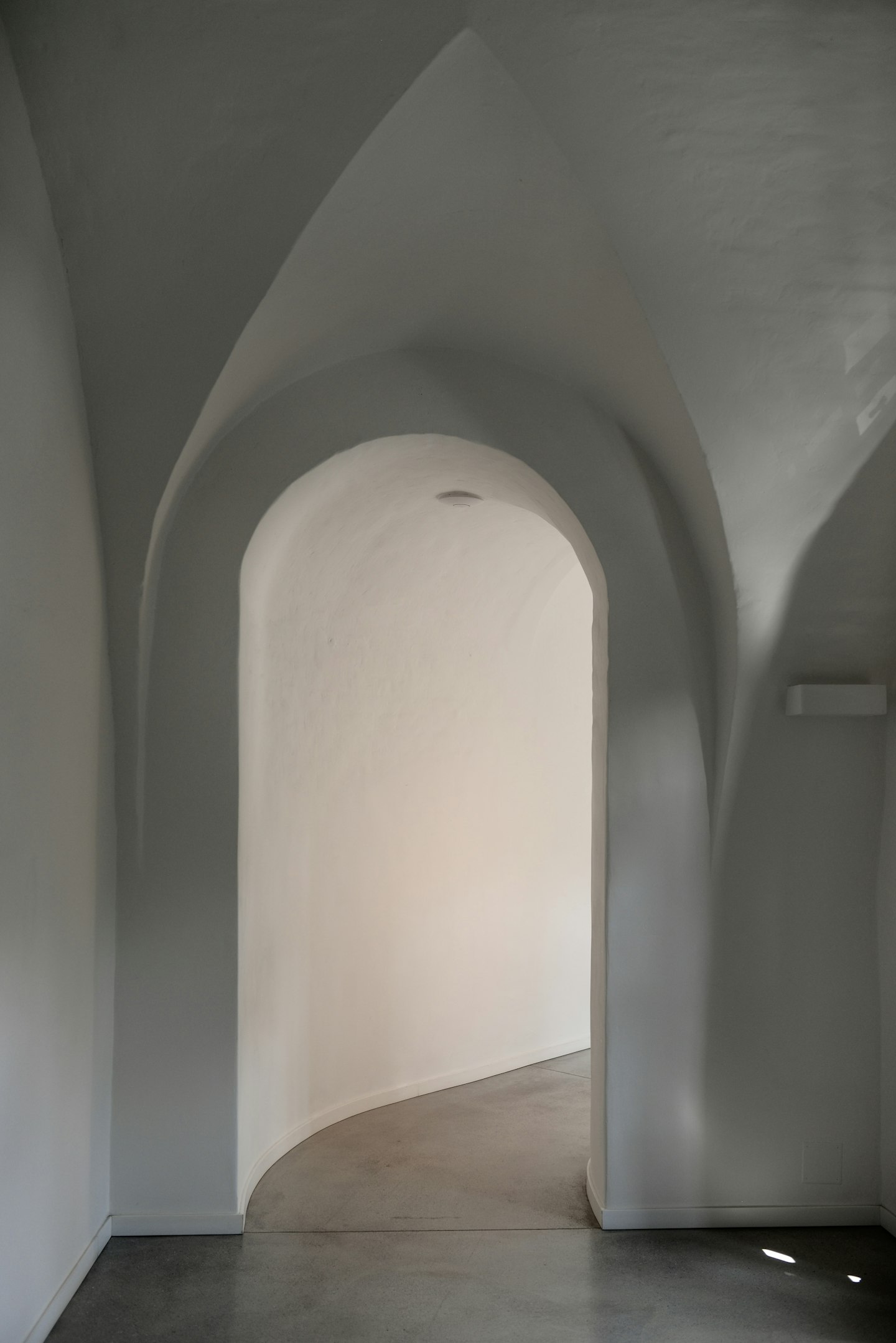 Sunlight moving across a plastered arch