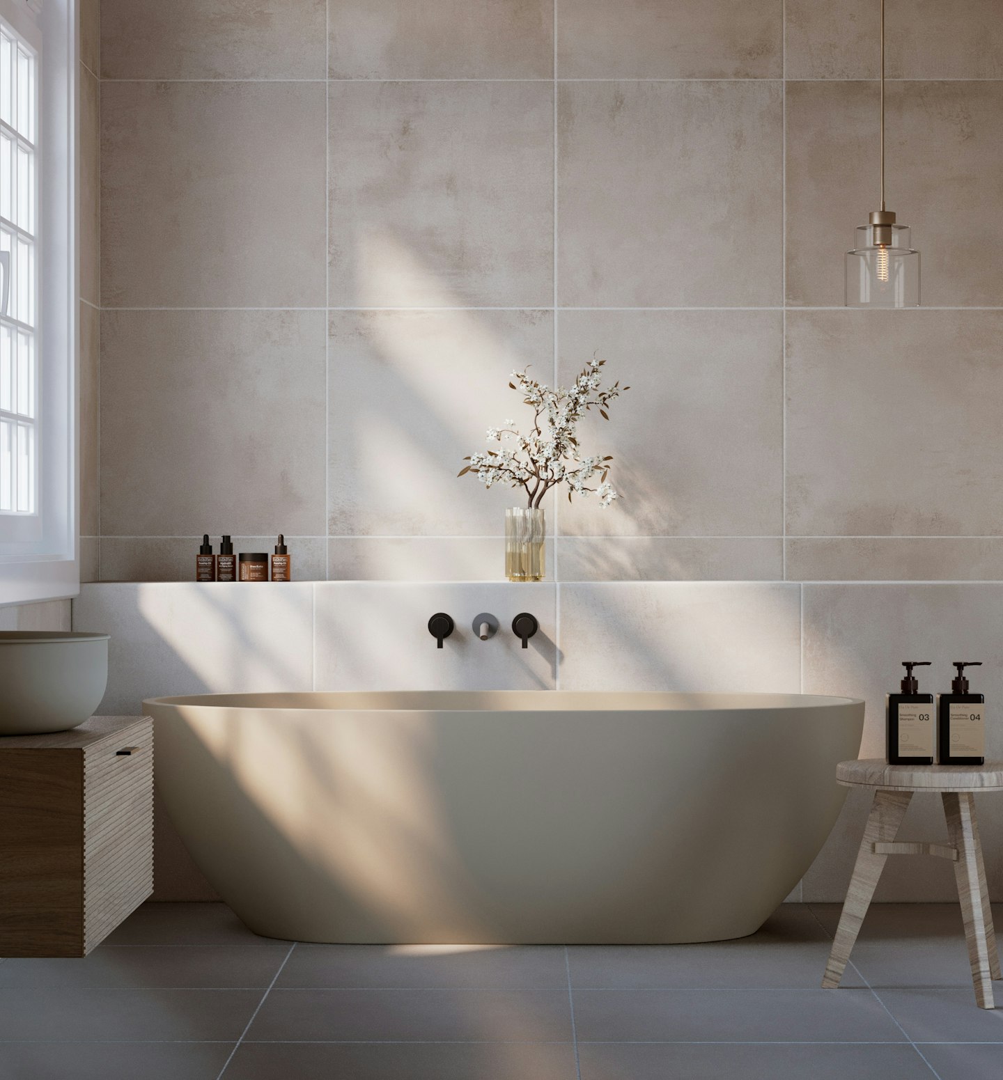 A freestanding bathtub in a light, minimal bathroom