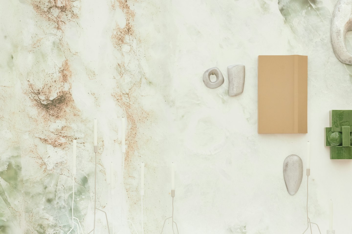 Stone, wood and textile samples laid out on a white surface