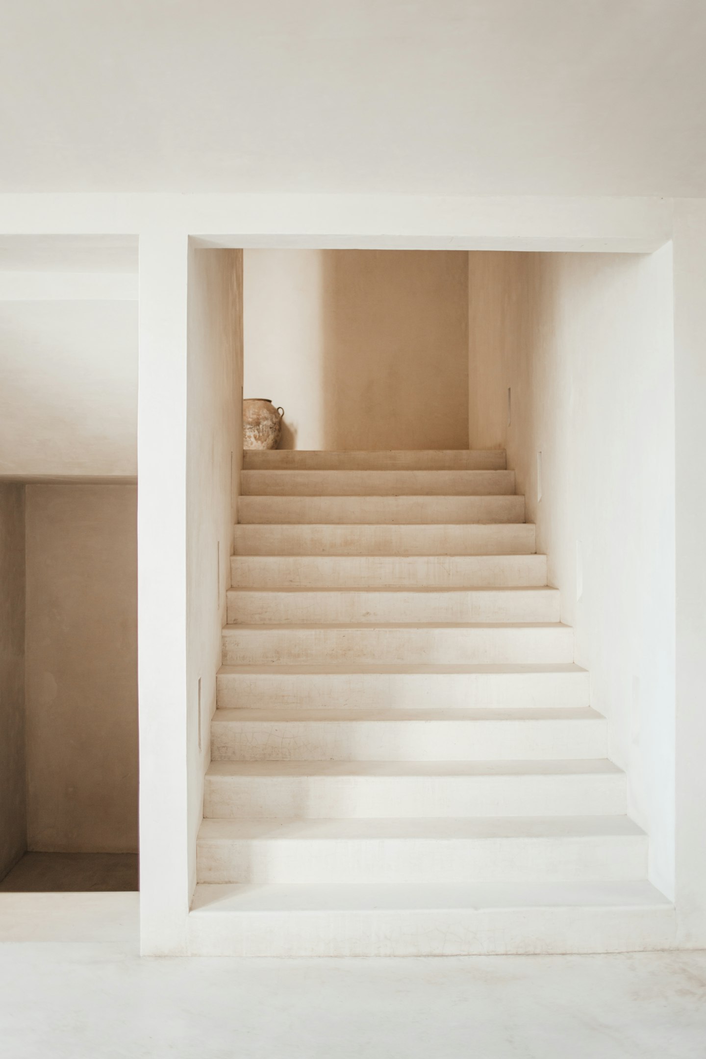 A minimal staircase in beige plaster