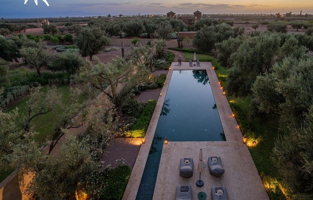 Villa YAH, Marrakech: the pool and garden from above at dusk