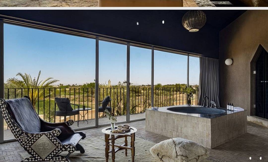 Villa YAH, Marrakech: a suite terrace with a stone bath and view over the palms
